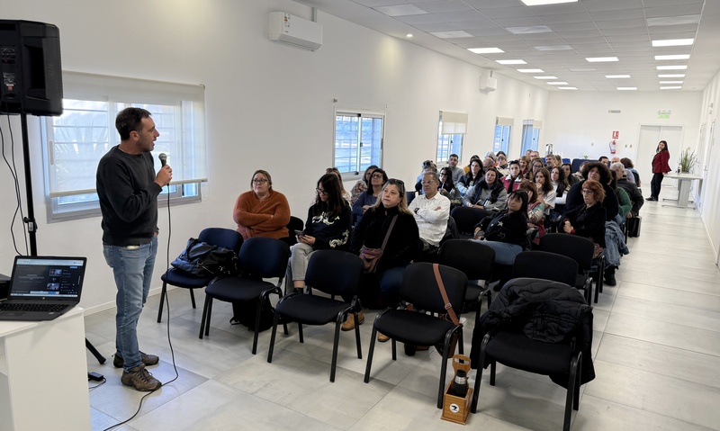 Persona hablando y participantes sentados