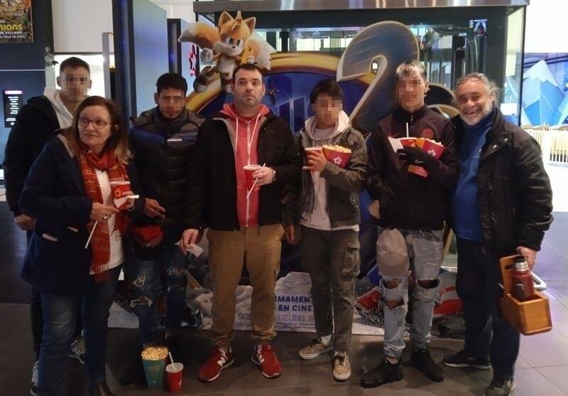 Educadores y jóvenes en la entrada del cine.