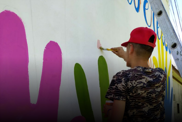 Joven pintando muro